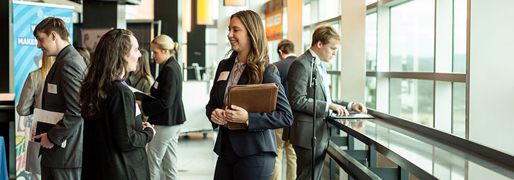 students conversing at a recruiting event