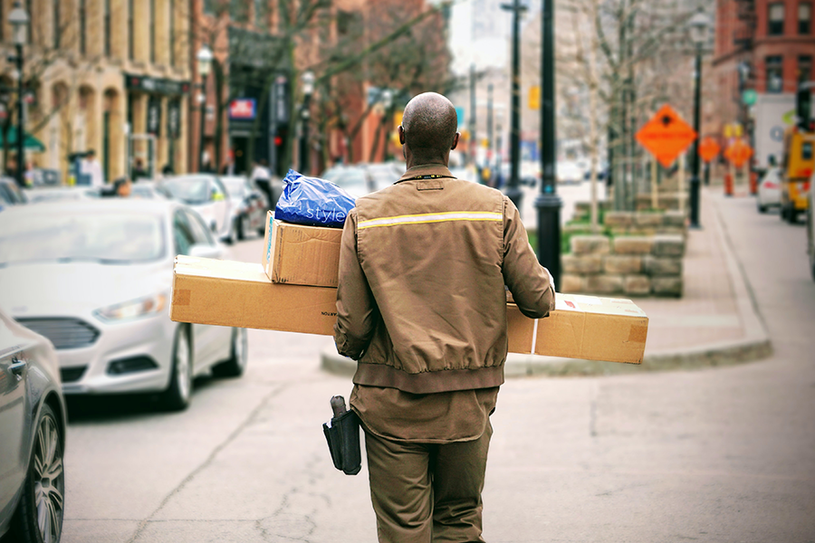a delivery man carrying packages