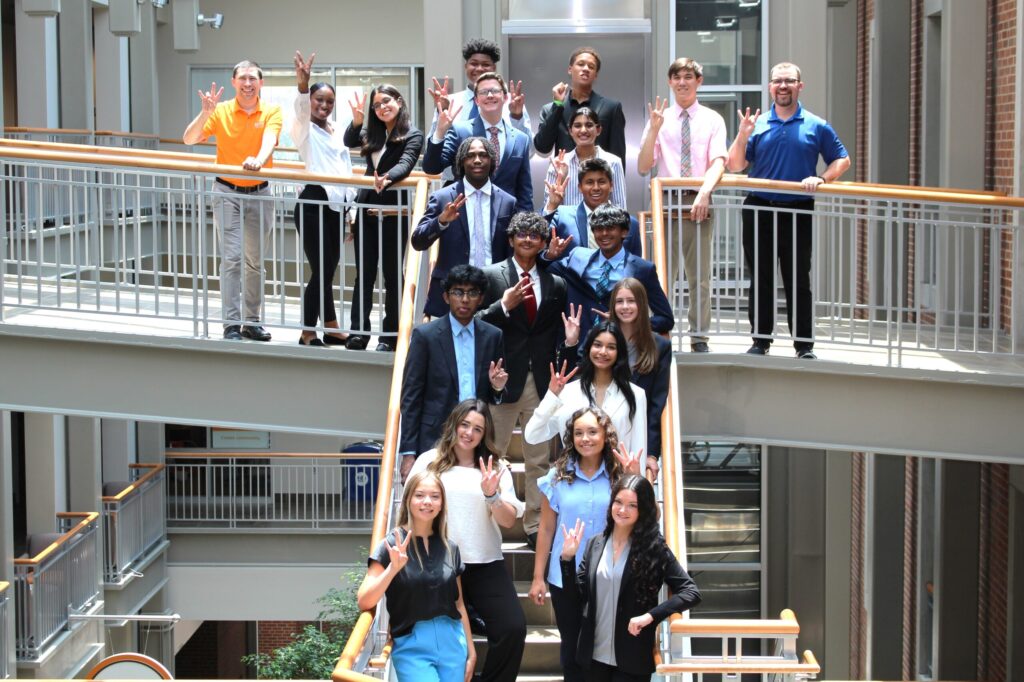 High school students in UT's SCM Summer Camp posing in the Haslam Business Building