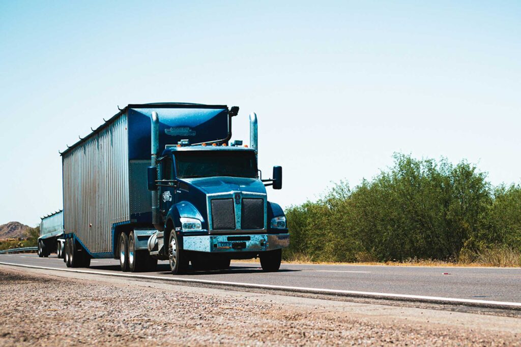 A semi truck driving on a road.