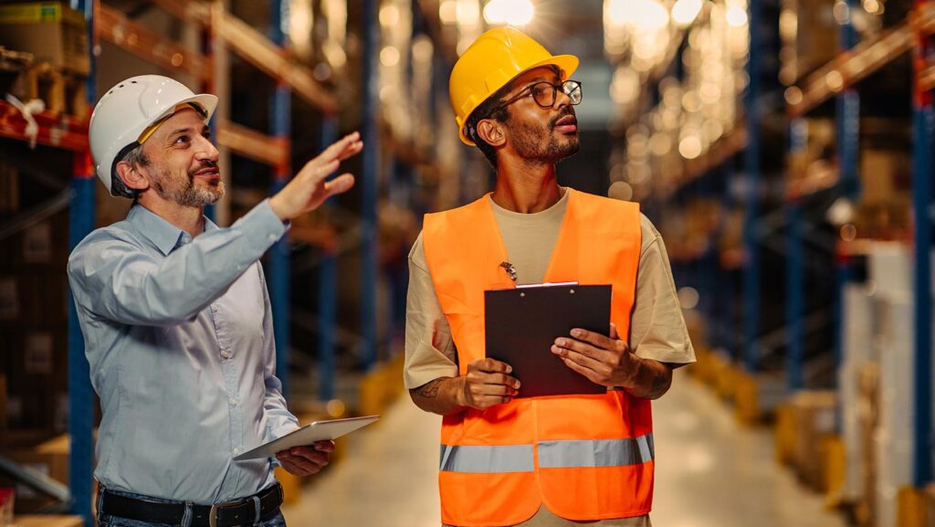 Two warehouse employees working together in a facility.